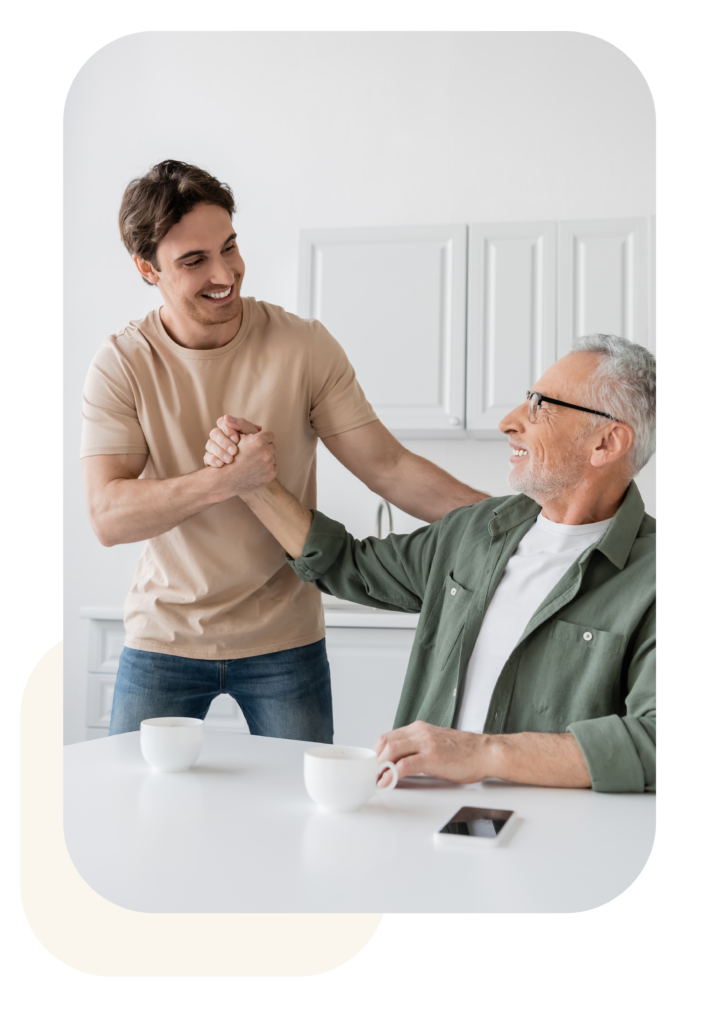 Smiling Mature Man Leans Against Glass Wall – Waypoint Family Business Advisory